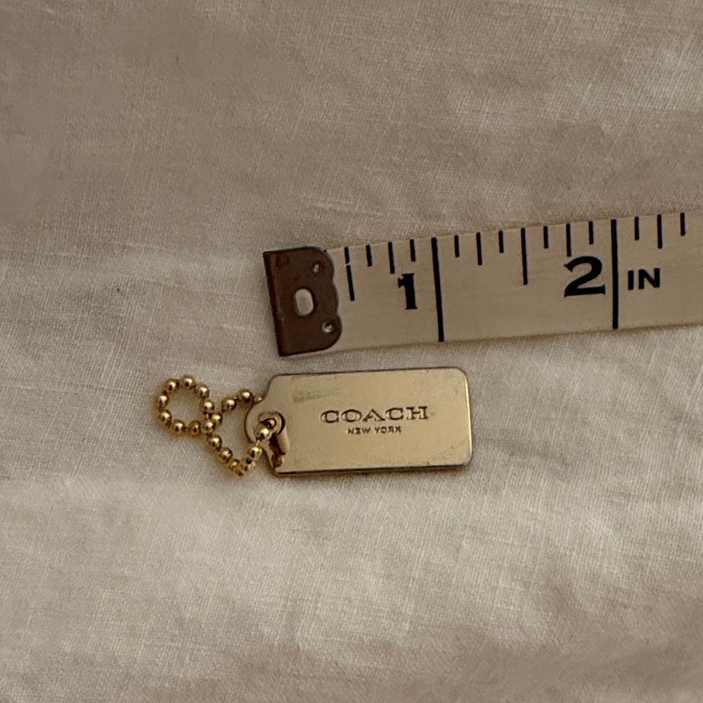 Coach hang tag with protective film